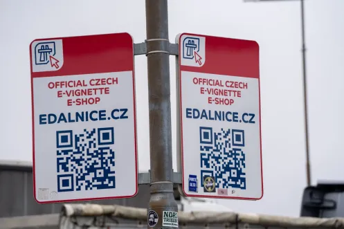 Official Czech e-vignette e-shop sign for edalnice.cz with QR code at a One1 petrol station near the Rozvadov border crossing, captured on February 25, 2026